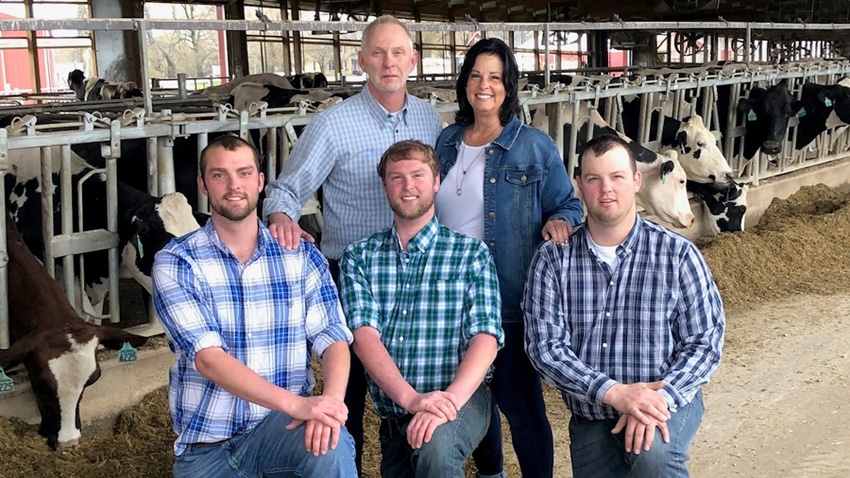 Roger and Tammy Weiland with sons Brady, Brett and Bryce, and dairy cows in the background Roger and Tammy Weiland with sons Brady, Brett and Bryce, and dairy cows in the background