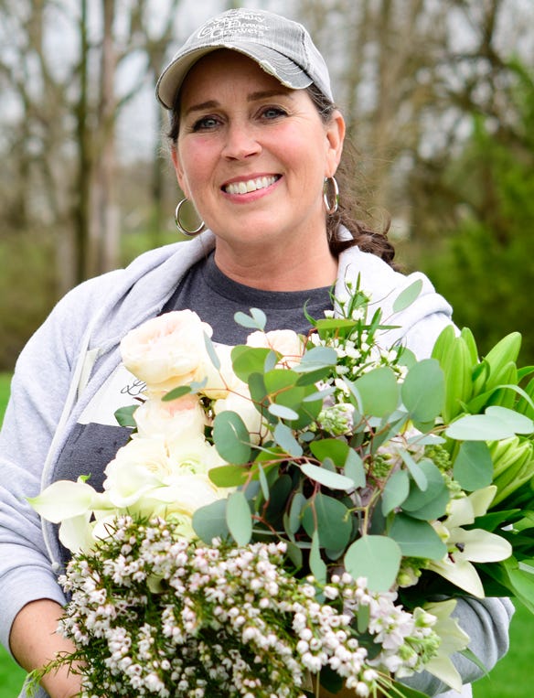Tracy Lawyer holding a bouquet of flowers