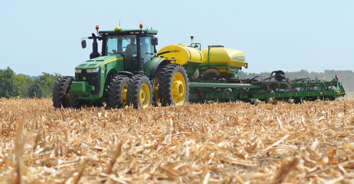 Robert Bonnie on tractor in cornfield Robert Bonnie on tractor in cornfield