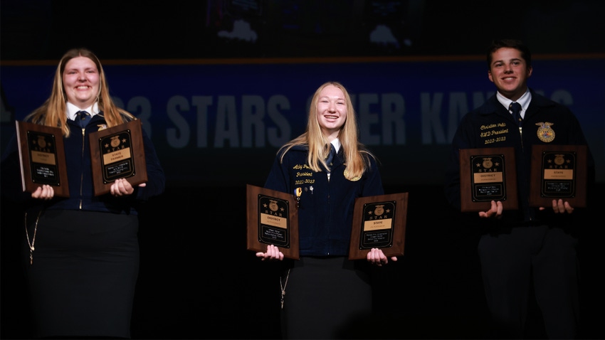 3 FFA members each holding 2 plaques onstage