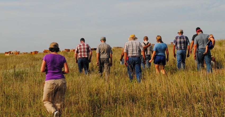 Farmers walk a pasture during a Nebraska Grazing Lands Coalition annual summer tour 