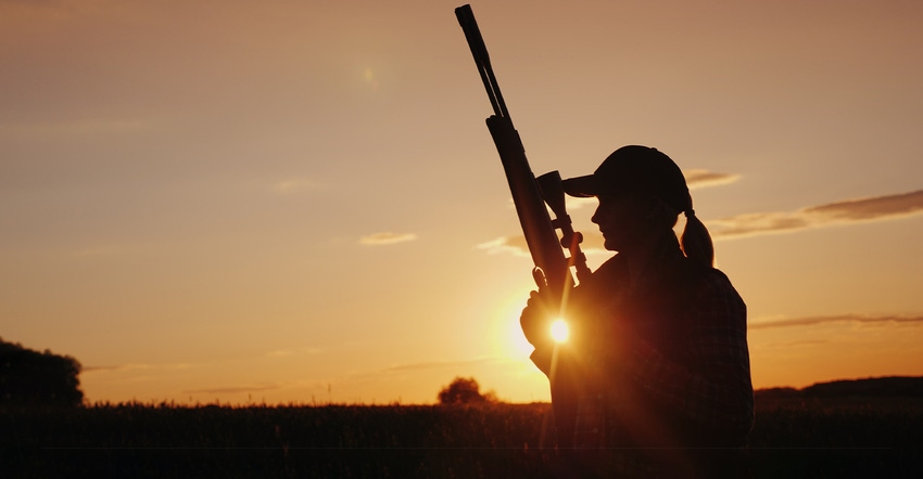 silhouette of female with hunting rifle