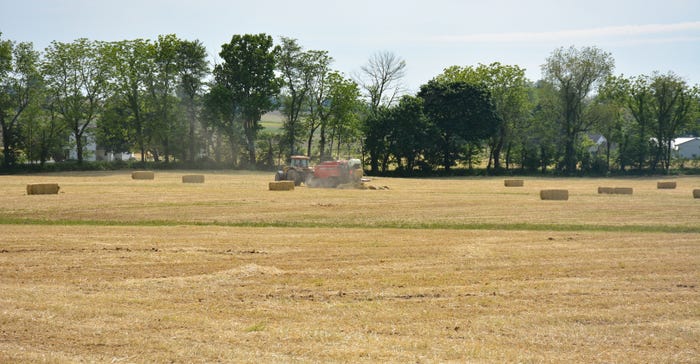 A Berks County farmer bales some hay on a sunny day
