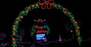 A holiday lights display in a park at night