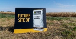 Future site of Wyffels hybrids sign in front of corn field