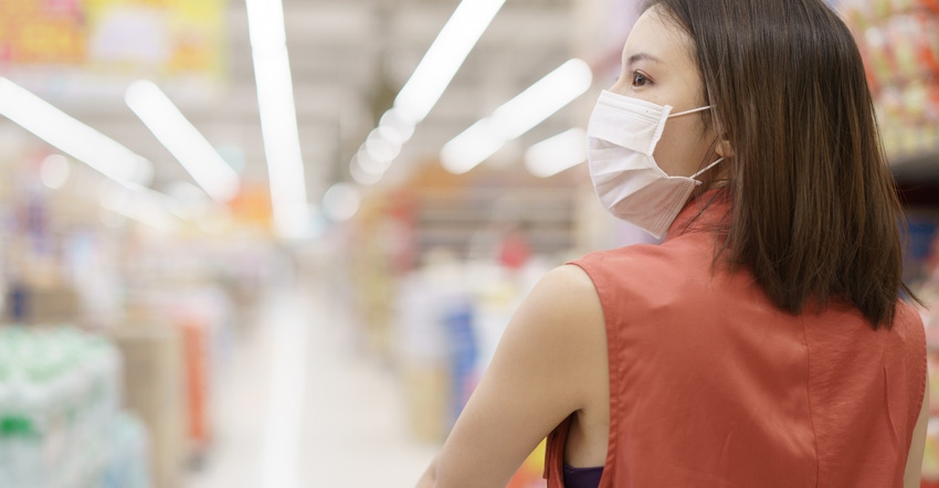woman in medical protective mask buying food 