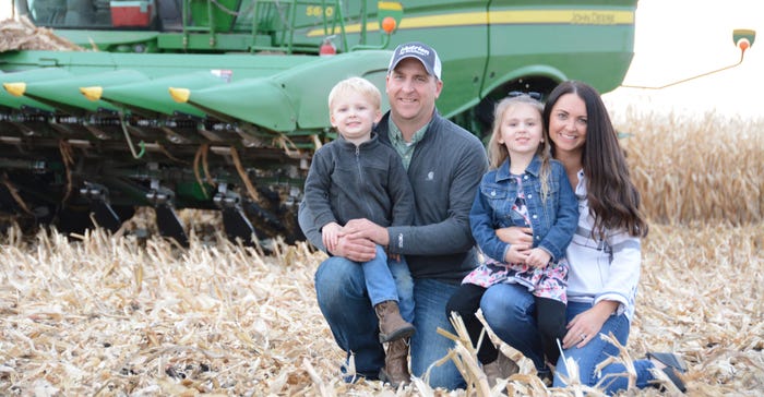 Seth and Jessica Lambert with kids Addison and Rhett in harvested cornfield