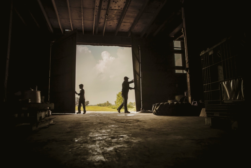 Father and son opening barn doors.