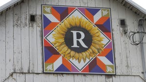  A colorful barn quilt painted on the front facade of a barn
