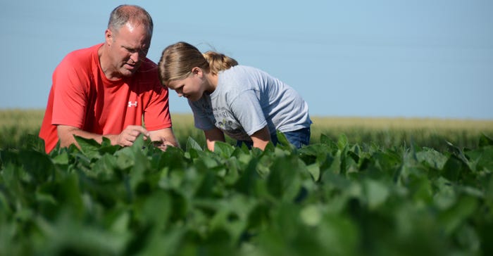 Macie and Andy Bartlow in soybean field