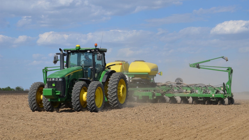 A tractor planting crops in a field