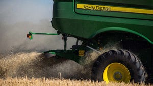 John Deere combine harvesting field.