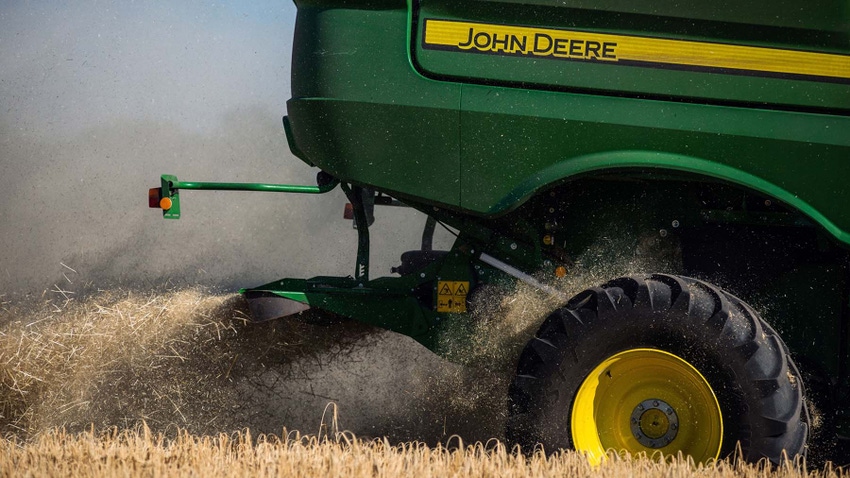 John Deere combine harvesting field.