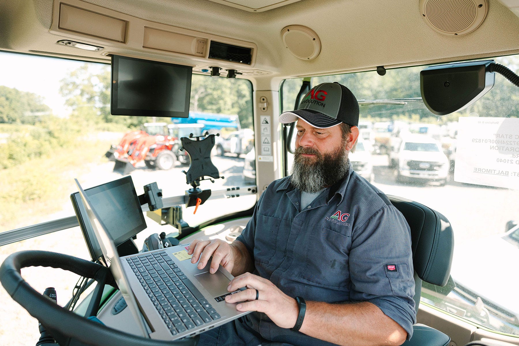 AgRevolution technician inside cab of mobile service truck AgRevolution technician inside cab of mobile service truck