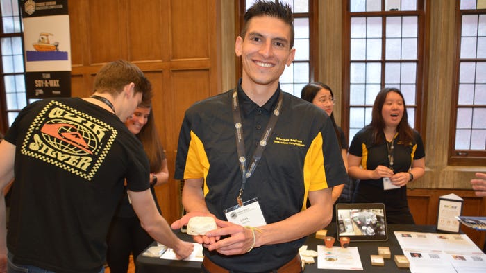 Louis Caceres Martinez, holding team StyroSoy's product, biodegradable alternative to Styrofoam from soybeans, in his hand