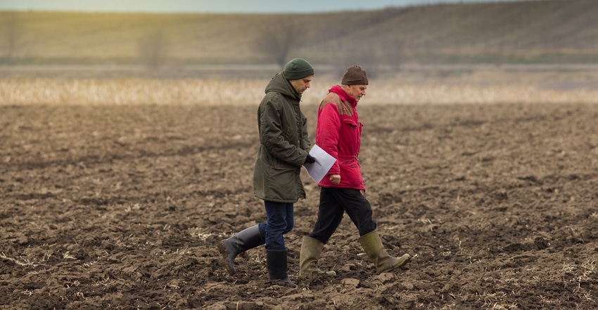 TWO FARMERS WALKING IN FIELD TWO FARMERS WALKING IN FIELD
