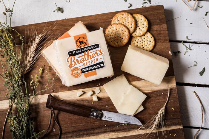 A cheese and cracker board display with Hemme Brothers Creamery products