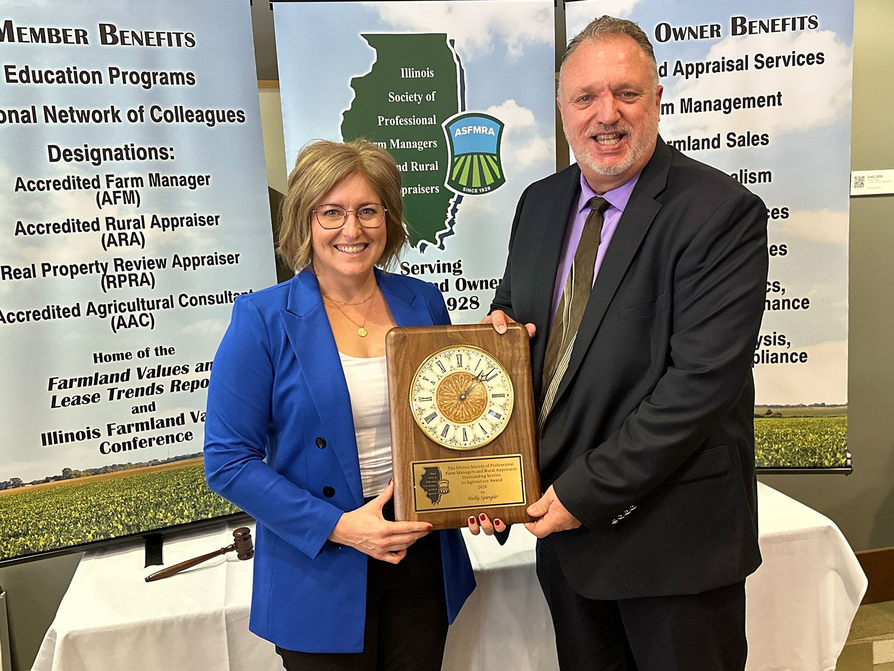 Holly Spangler and Michael Lauher holding a plaque