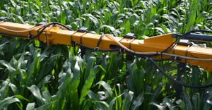 closeup of sprayer boom applying nitrogen in corn