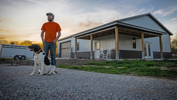 Matt Sampson of Petersburg, Illinois, standing outside of his combination shop and house