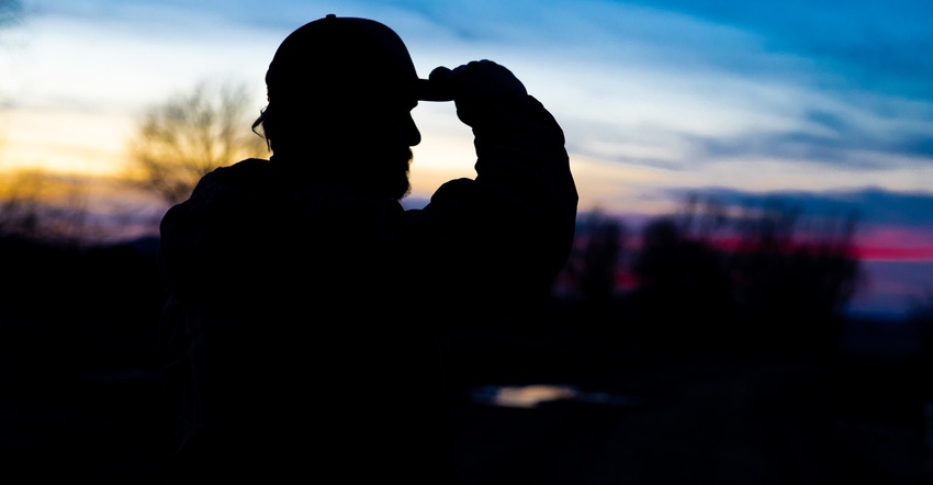 silhouette of farmer Dan Haynes looking out over farmland silhouette of farmer Dan Haynes looking out over farmland