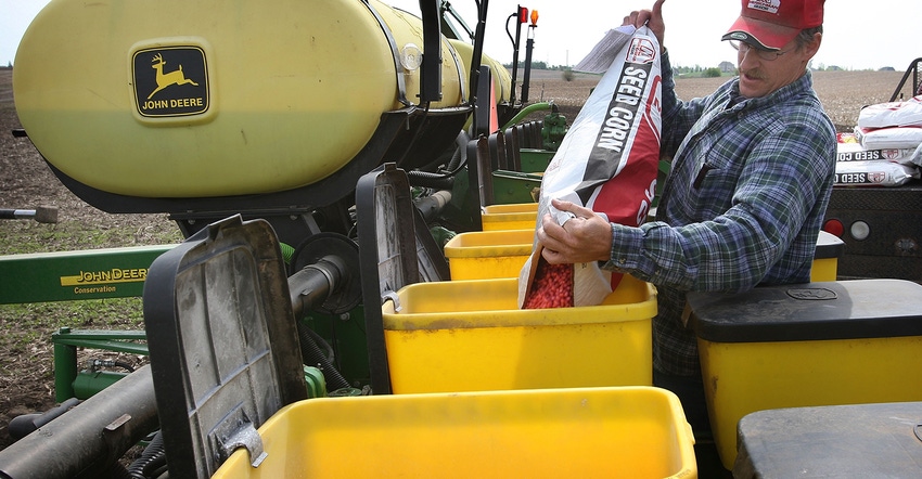 farmer filling planter with seed corn