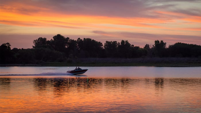 Sunset over boat on lake