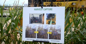sign in cornfield explaining technology that measure ear height on combine