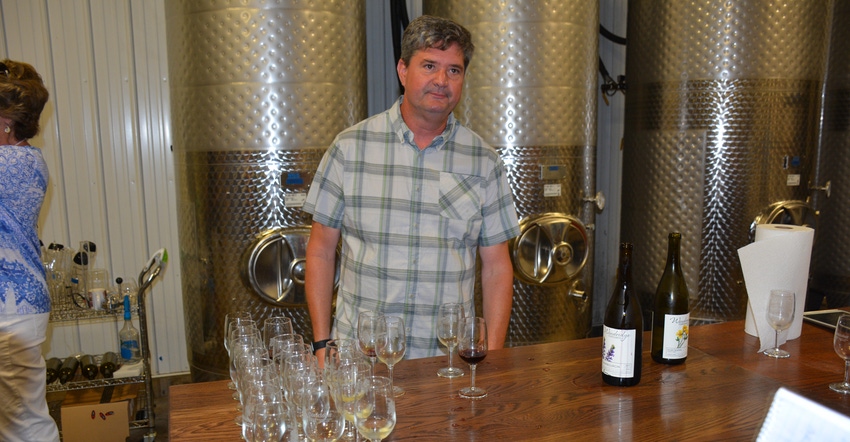 Robert Butz, who runs Windridge Farm, serves wine to customers