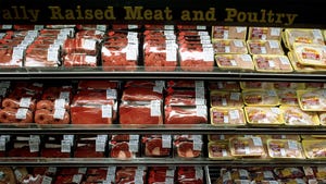 Packaged red meat and poultry in a grocery store cooler