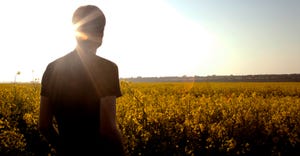 farmer in field at sunset