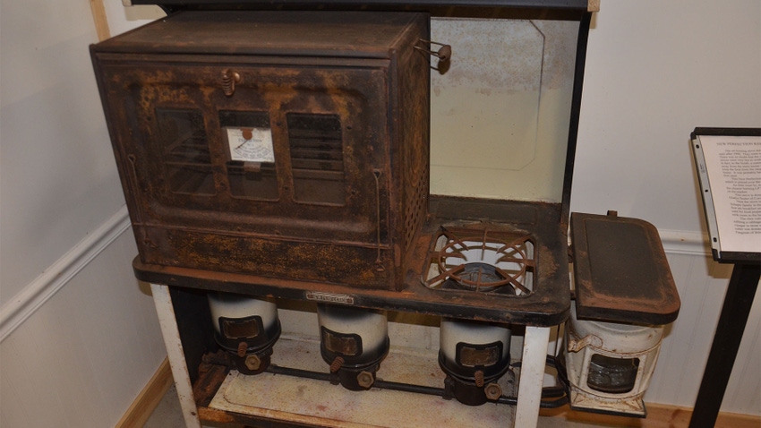 an antique cookstove with detachable oven on top