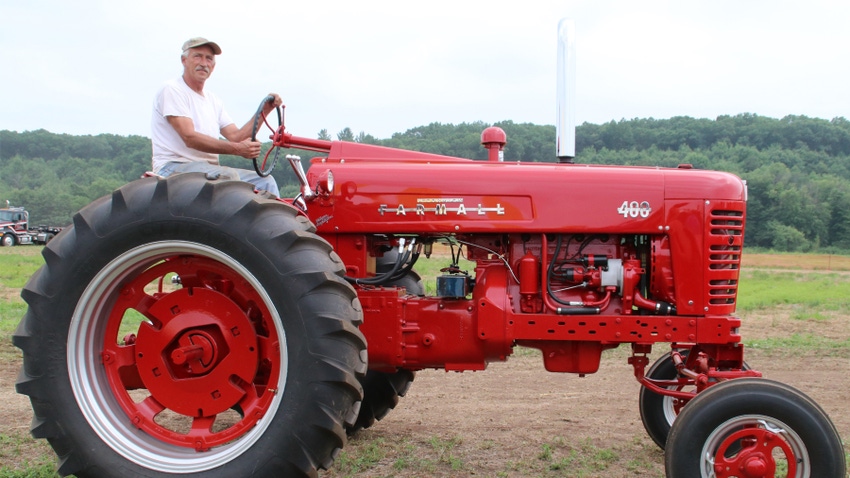 Glen Green sits on his 400 Farmall tractor