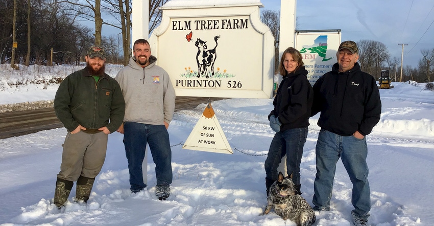 Doug and Julie Purinton, and their sons, Jordan and Nathan, stand beside the sign for Elm Tree Farm Doug and Julie Purinton, and their sons, Jordan and Nathan, stand beside the sign for Elm Tree Farm