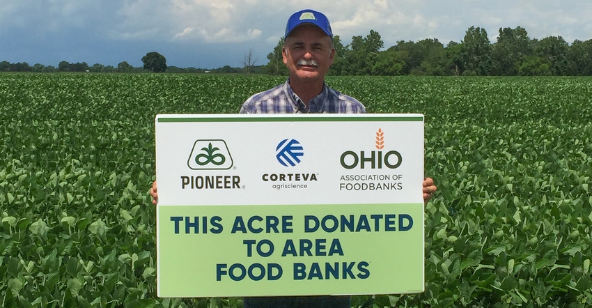 David Brewer, Pioneer sales representative, holds up a donation sign