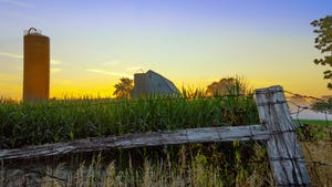 Farm and silo at sunset