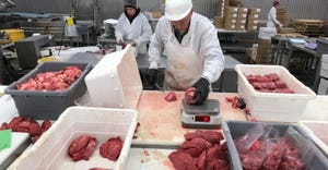 Workers process meat at Byron Center Meats in Byron Center, Michigan