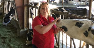 Amber Adams Progar pets a cow