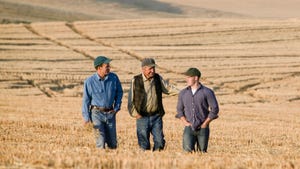 three generations of farmers in field