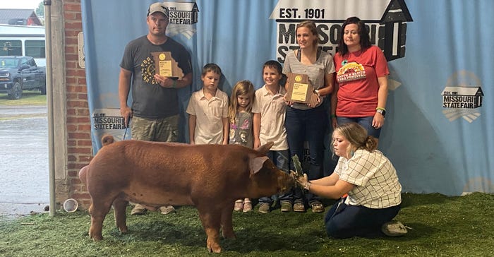 Humphreys family with pigs at the Missouri State Fair