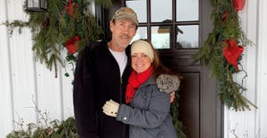 Mike and Joy McClain in front of their front door