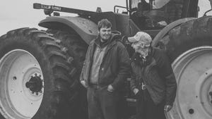 Mark Thomas and his grandfather, the late Kenneth Weatherby, share a laugh near the grain cart
