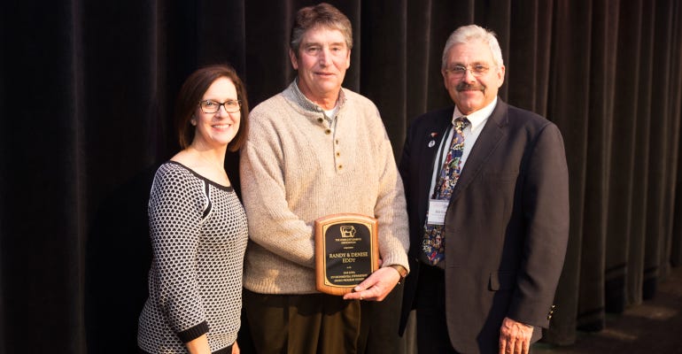 Denise and Randy Eddy (left), ICA 2018 Environmental Stewardship Award winner, shown with past winner and award presenter Bill Couser