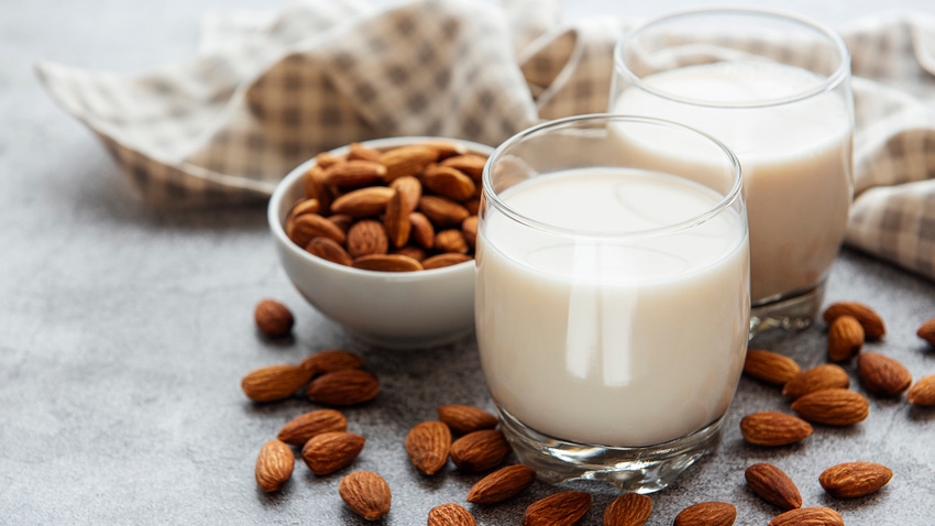 Two glasses of almond milk on a table Two glasses of almond milk on a table