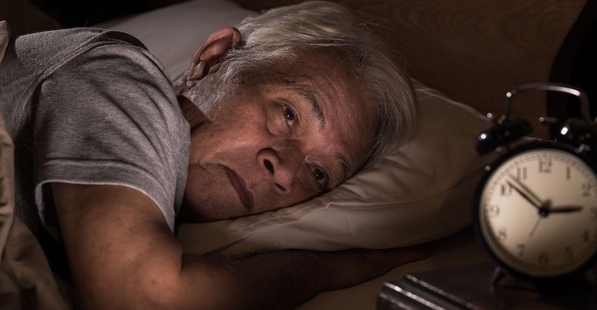 Older senior man lying in bed cannot sleep 