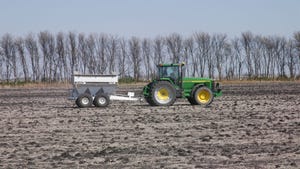 A tractor fertilizing a field