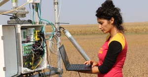 Woman researcher studying the impacts of adding bioenergy crops like sorghum 