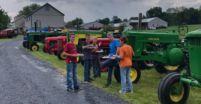 Boys snack at the annual tractor reunion at Andrew Fox’s farm, Newmanstown, Pa.