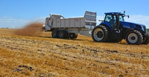truck spreader manure on field
