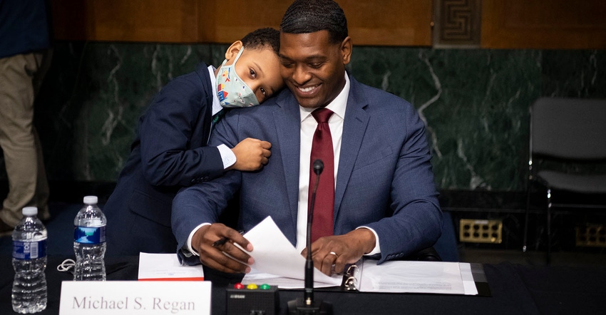 Nominee for Administrator of the Environmental Protection Agency Michael Regan is hugged by his son Matthew after his confir Nominee for Administrator of the Environmental Protection Agency Michael Regan is hugged by his son Matthew after his confir